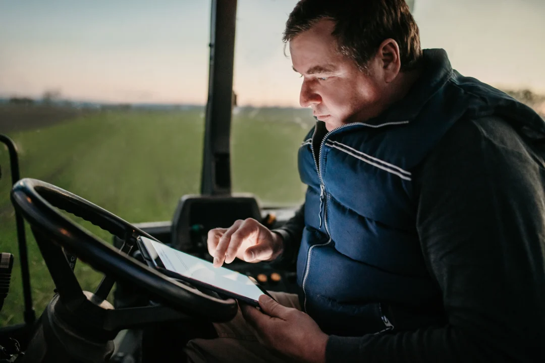A farmer consults a tablet