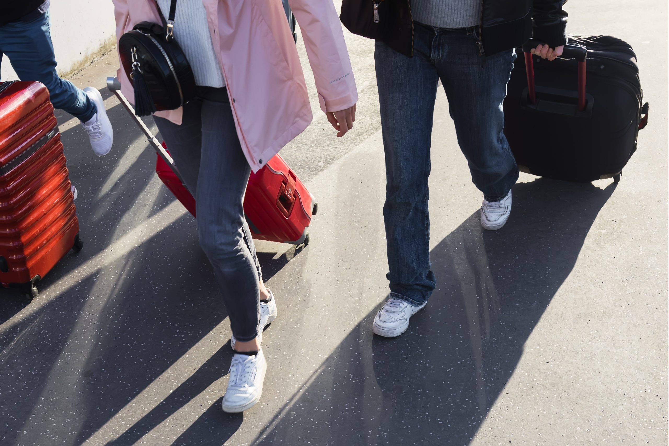 people on the move with wheeled suitcases